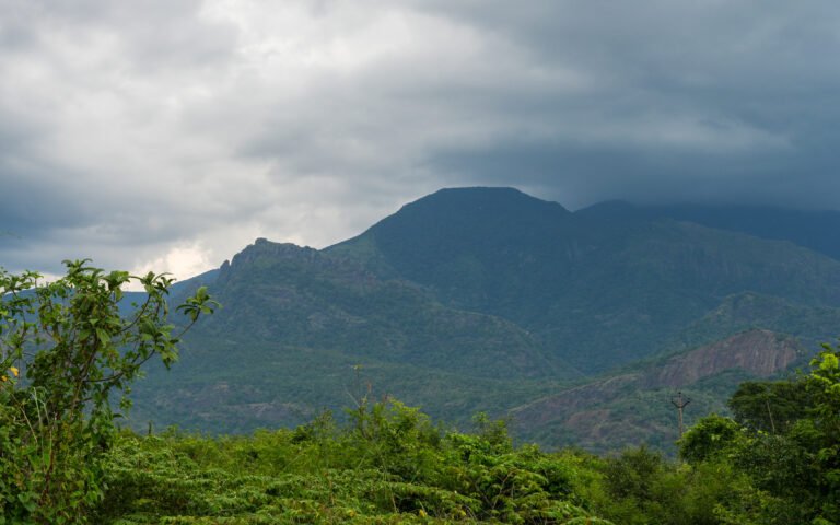 Green mountain slopes beneath a soft, cloudy sky