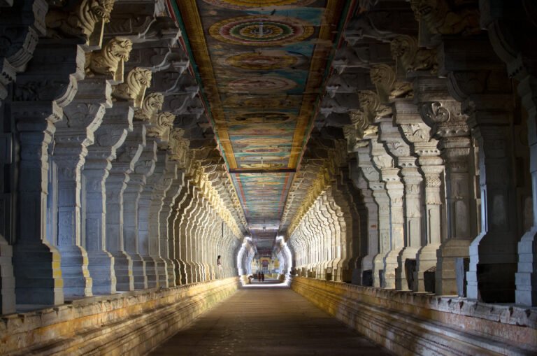 A long pillared stone corridor inside a historic temple