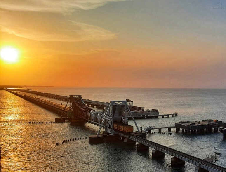 A long causeway stretching across the sea towards the horizon at sunset
