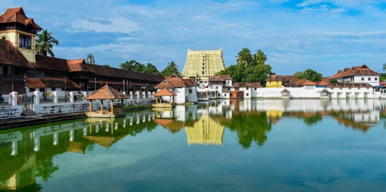 An ornate temple complex reflected in a still temple tank at dusk