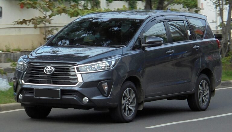 A grey SUV photographed from the front