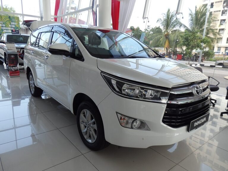 A white SUV parked indoors at a showroom