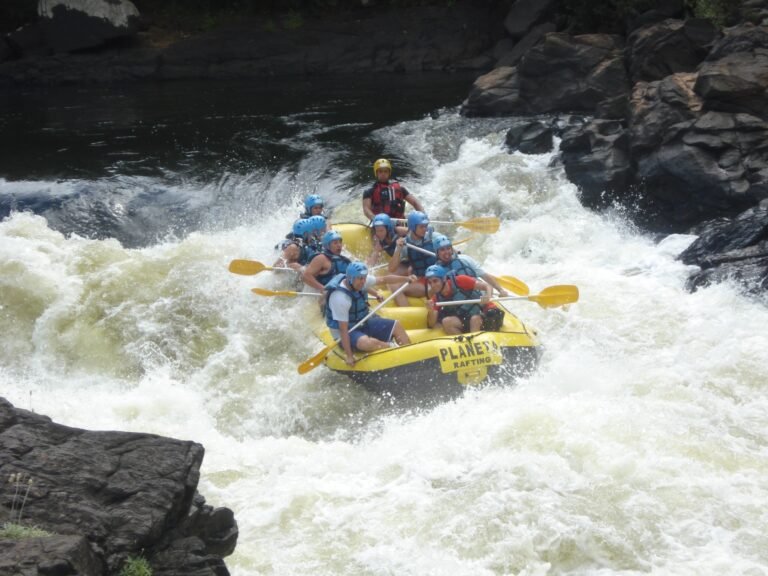 A group white-water rafting through churning river rapids